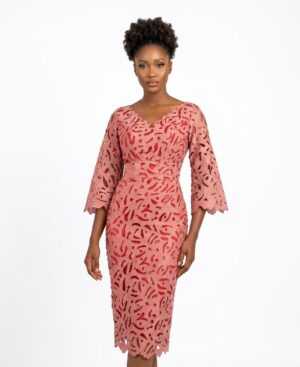 Model wearing a dusty rose laser-cut Aso Ebi lace midi dress with bell sleeves and scalloped neckline against a white background.