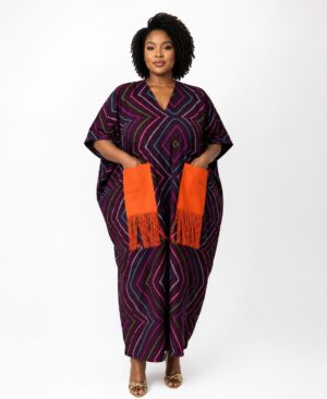 Plus size woman wearing a purple geometric print African kaftan with oversized orange fringe pockets.