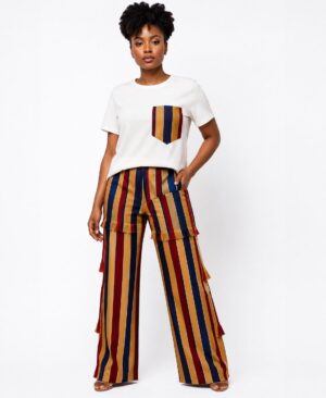 Black woman wearing African Print Striped Two-Piece Set featuring a white t-shirt and navy, mustard, and burgundy striped wide-leg pants with fringe detailing.