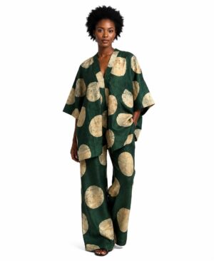 Woman wearing a forest green and cream batik print kimono and matching wide-leg trousers.