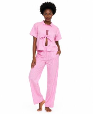 Black woman with natural hair wearing a pink and white pinstripe two-piece set with a tie-front top and high-waisted trousers against a white background.