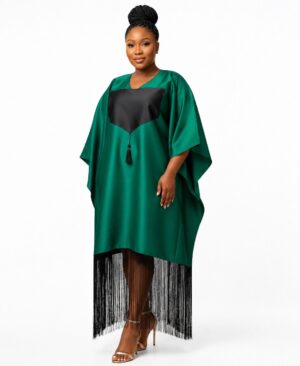 Woman wearing a loose emerald green silk-satin kaftan dress with a black tassel and long black fringe hem.