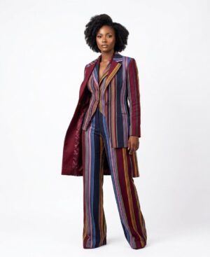 Model wearing a three-piece African fashion set featuring a burgundy and navy striped woven blazer, wide-leg trousers, and a long duster coat.