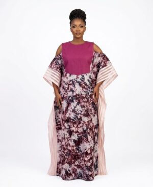 Woman wearing a floor-length plum and marble print Adire Bubu dress with cold-shoulder sleeves and sheer organza trim.