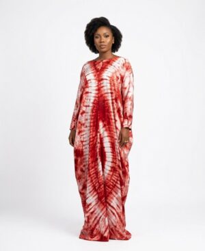 Model wearing a long-sleeved red and white Adire tie-dye Bubu kaftan dress against a white background.